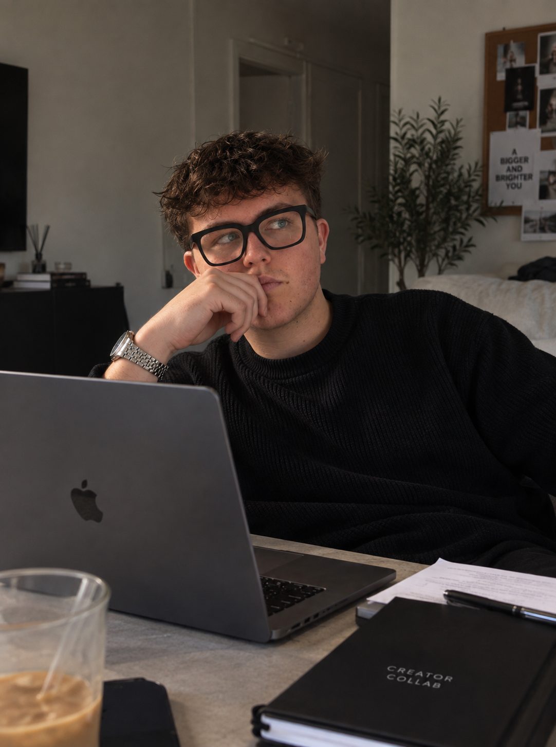 Jarvis at his desk with a laptop and a Creator Collab notebook